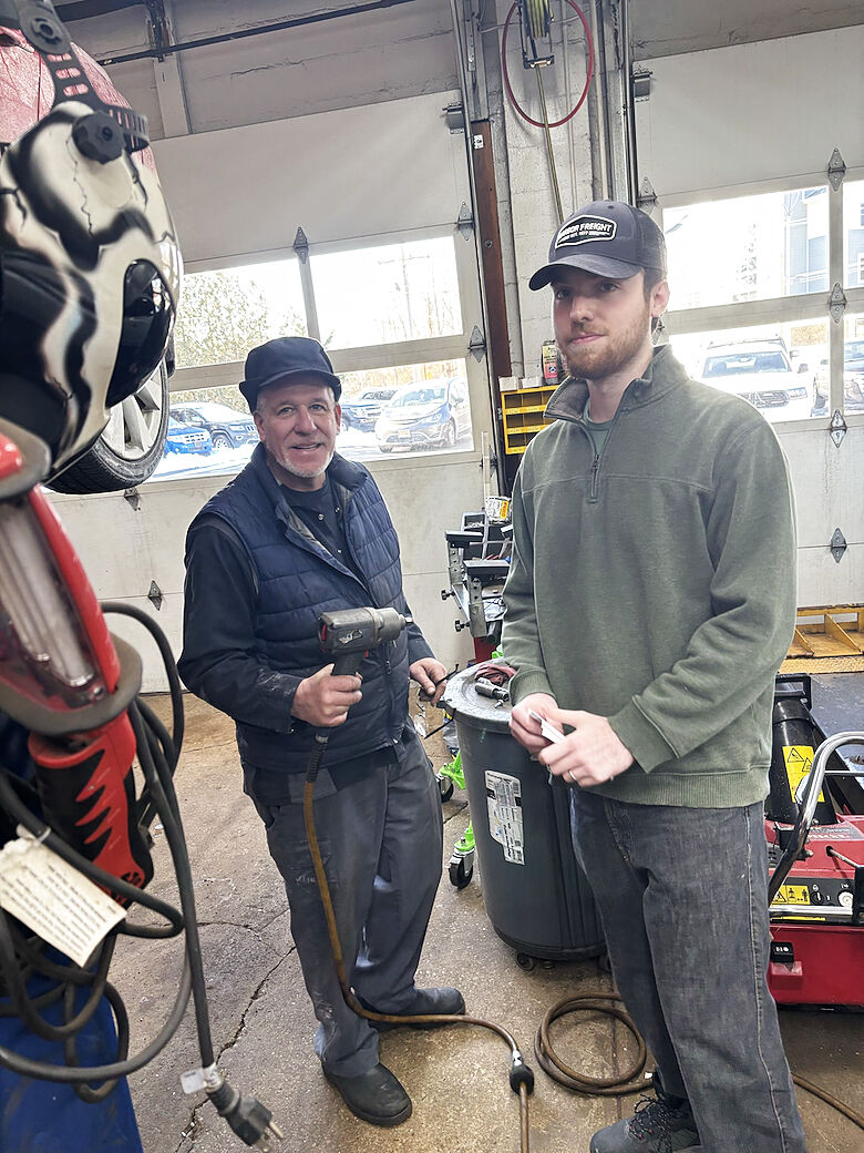 Technicians in the shop discussing their tools