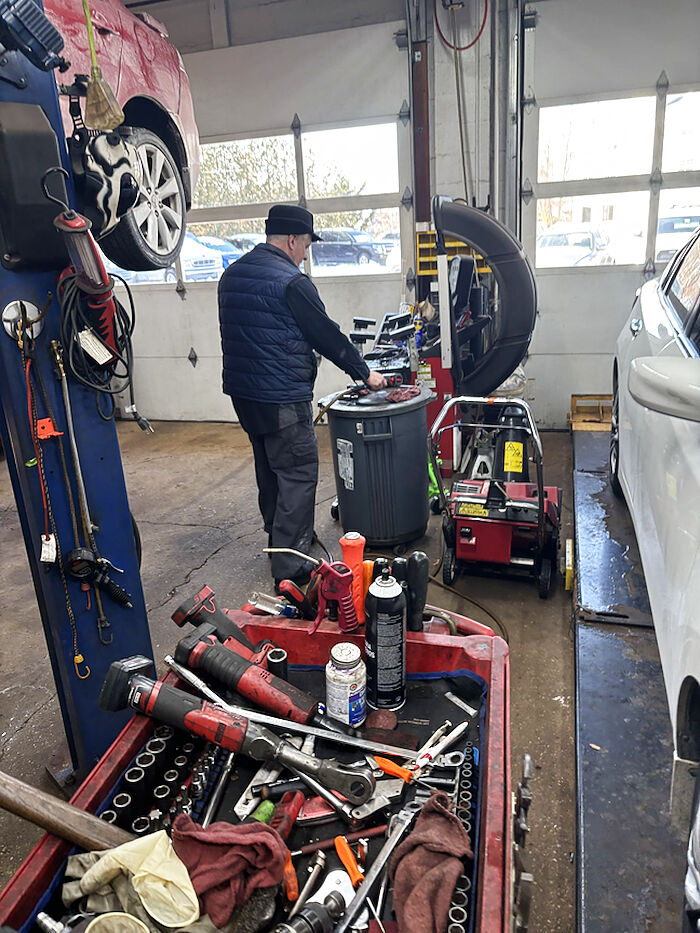 Shop bay with a tool cart and vehicle on a lift
